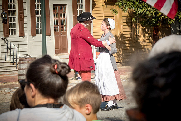 The tourists listening in on the townspeople discussing the issues of the day